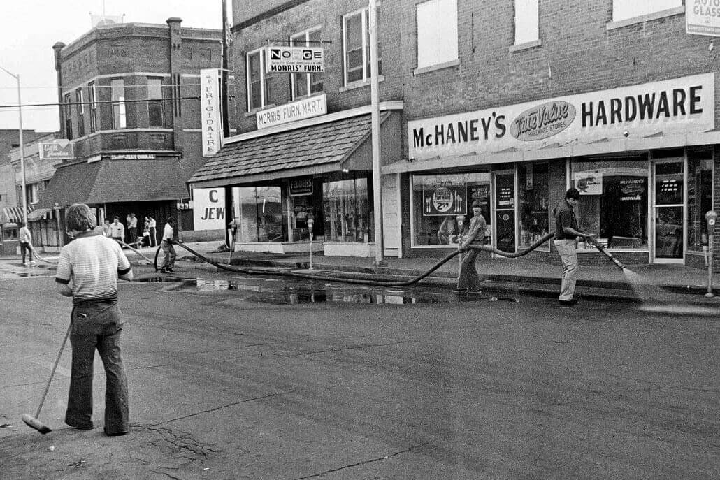 Historic photo of people cleaning the streets in Downtown Paragould.