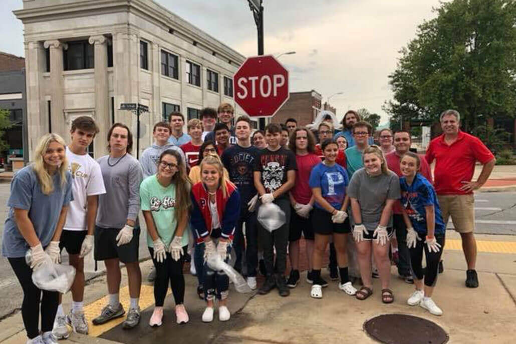 A Group of Kids cleaning the streets in Downtown Paragould.